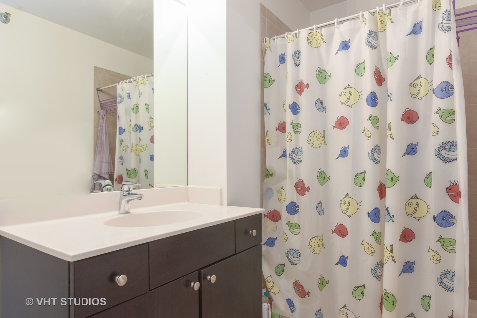 235 West Van Buren Street, Unit 3804 Chicago, IL 60607 - Photo 8 of 11 a bathroom with a sink a mirror a vanity and a shower curtain