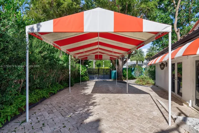 a backyard of a house with yard and outdoor seating