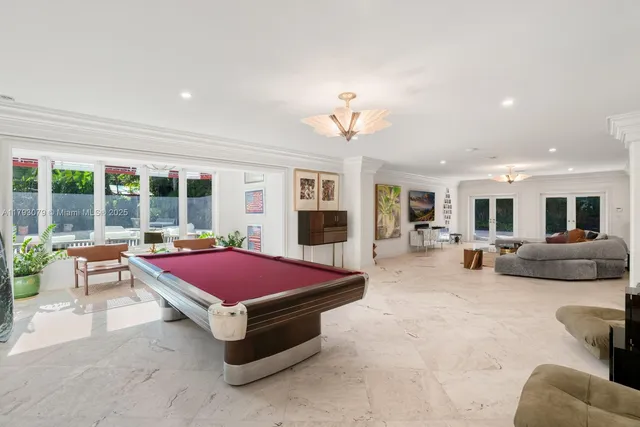 a living room with furniture and pool table