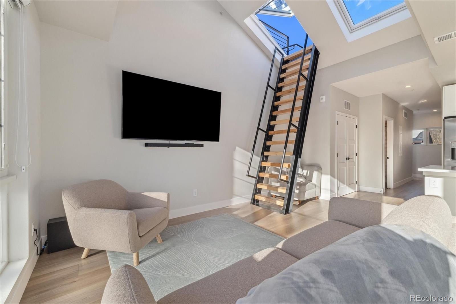 1401 Jackson Street, Unit 204 Golden, CO 80401 - Photo 13 of 26 a living room with furniture and a flat screen tv
