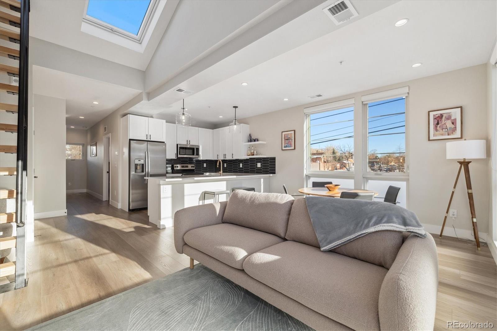 1401 Jackson Street, Unit 204 Golden, CO 80401 - Photo 15 of 26 a view of a living room kitchen with furniture and a wooden floor