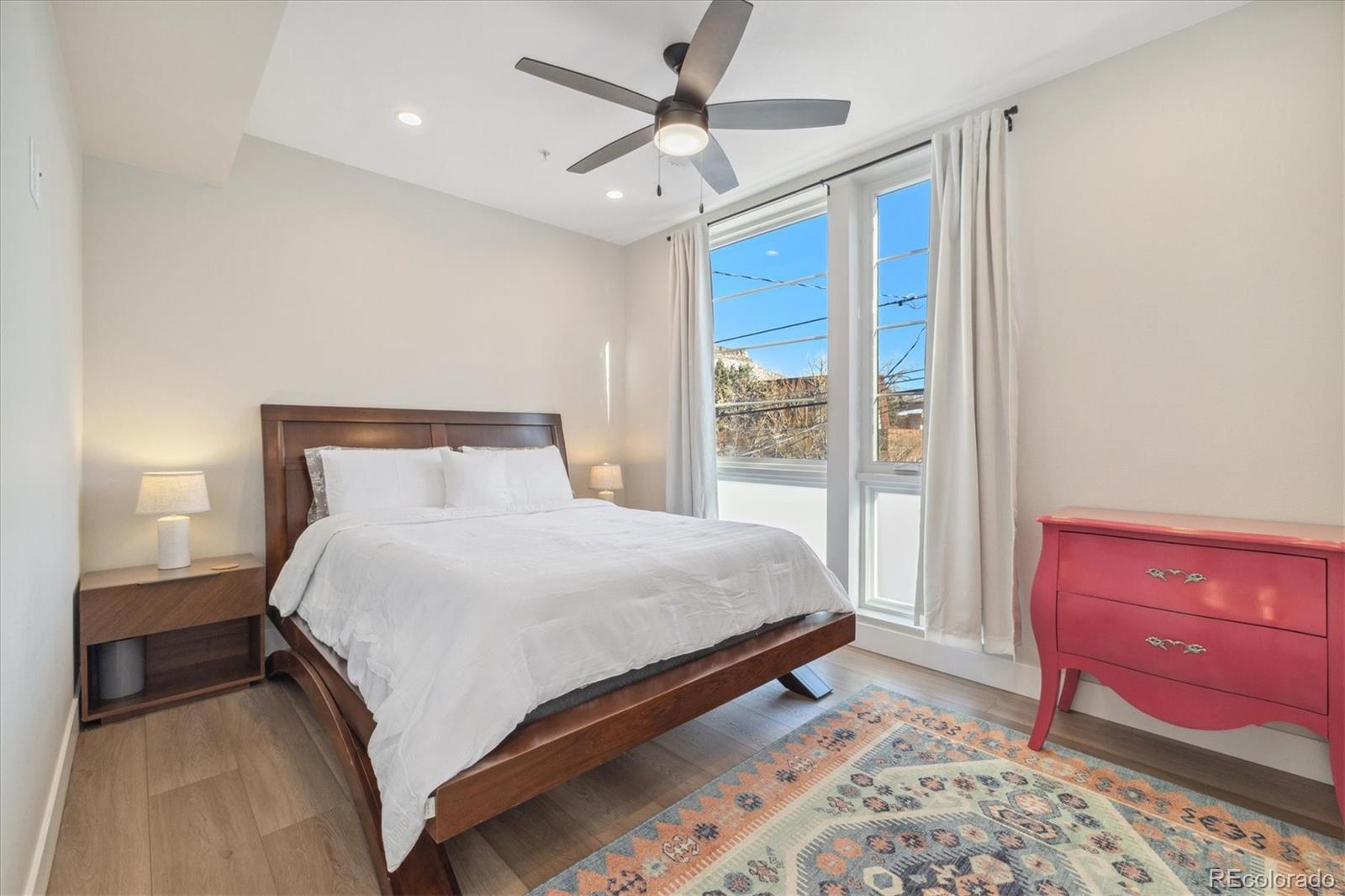 1401 Jackson Street, Unit 204 Golden, CO 80401 - Photo 17 of 26 a bedroom with a large bed and a chandelier