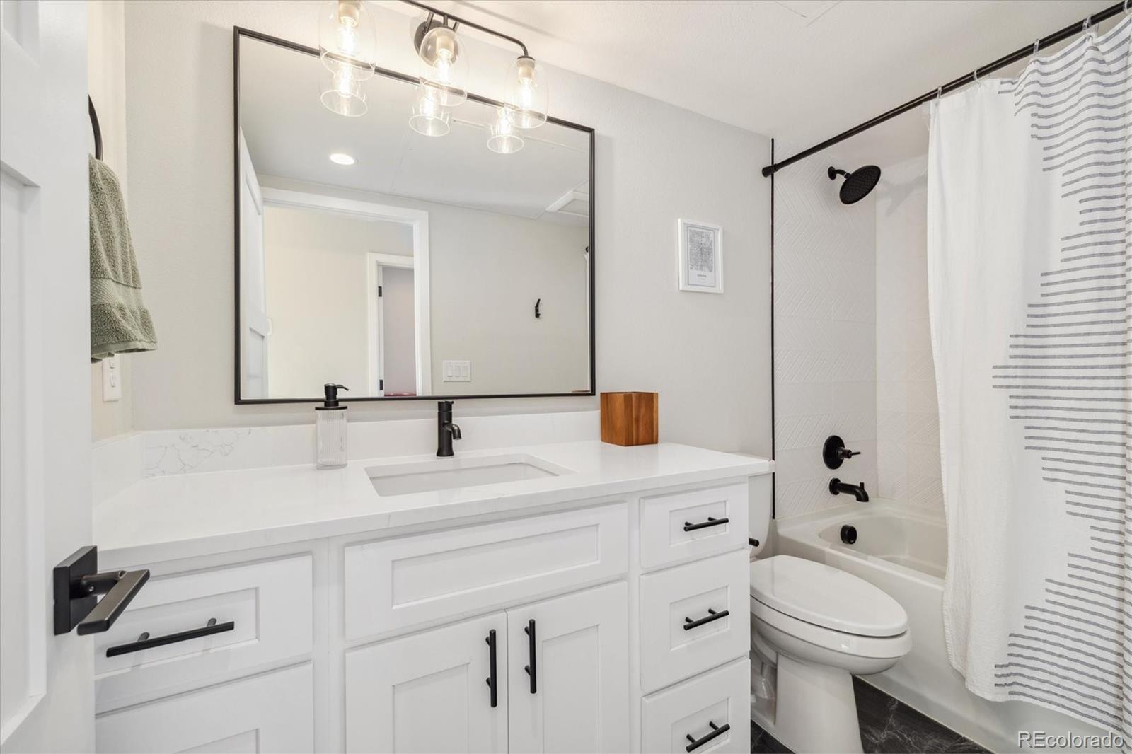 1401 Jackson Street, Unit 204 Golden, CO 80401 - Photo 19 of 26 a bathroom with a sink a toilet and shower