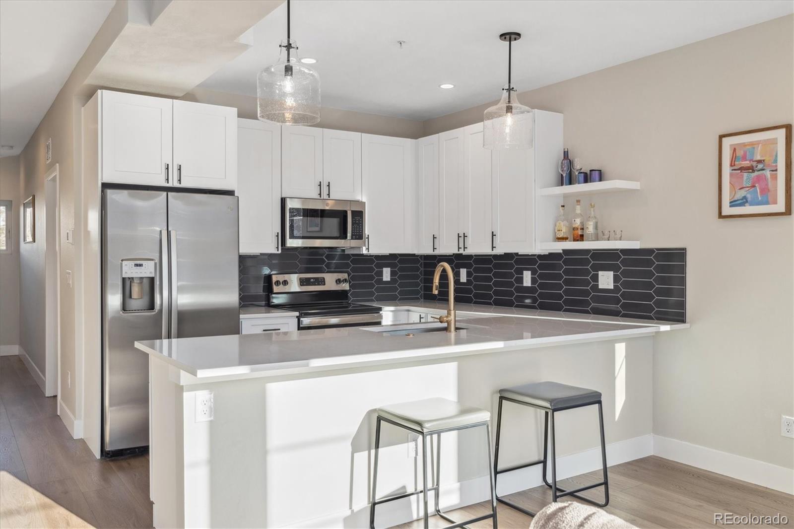1401 Jackson Street, Unit 204 Golden, CO 80401 - Photo 10 of 26 a kitchen with stainless steel appliances granite countertop a sink a stove a refrigerator cabinets and chairs
