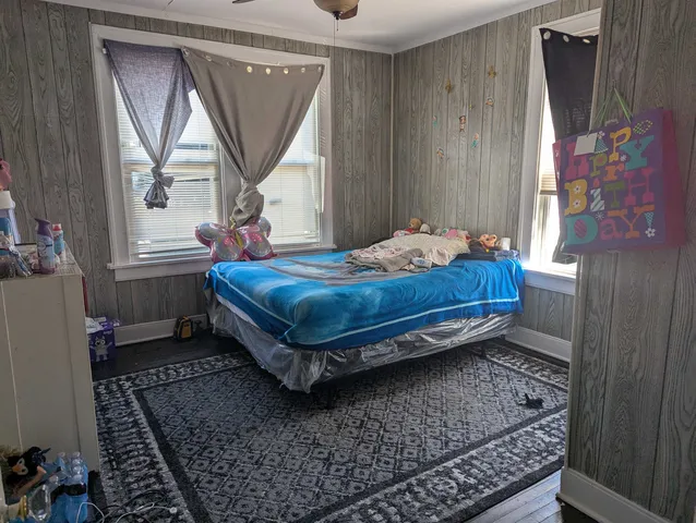 a bed sitting in a room next to a window
