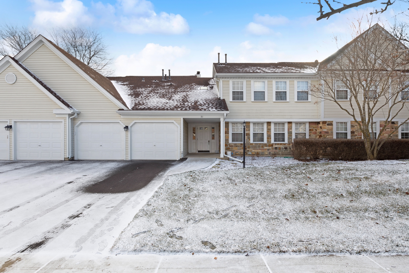 71 Larch Court, Unit B Schaumburg, IL 60193 - Photo 1 of 12 a view of a white house with a yard