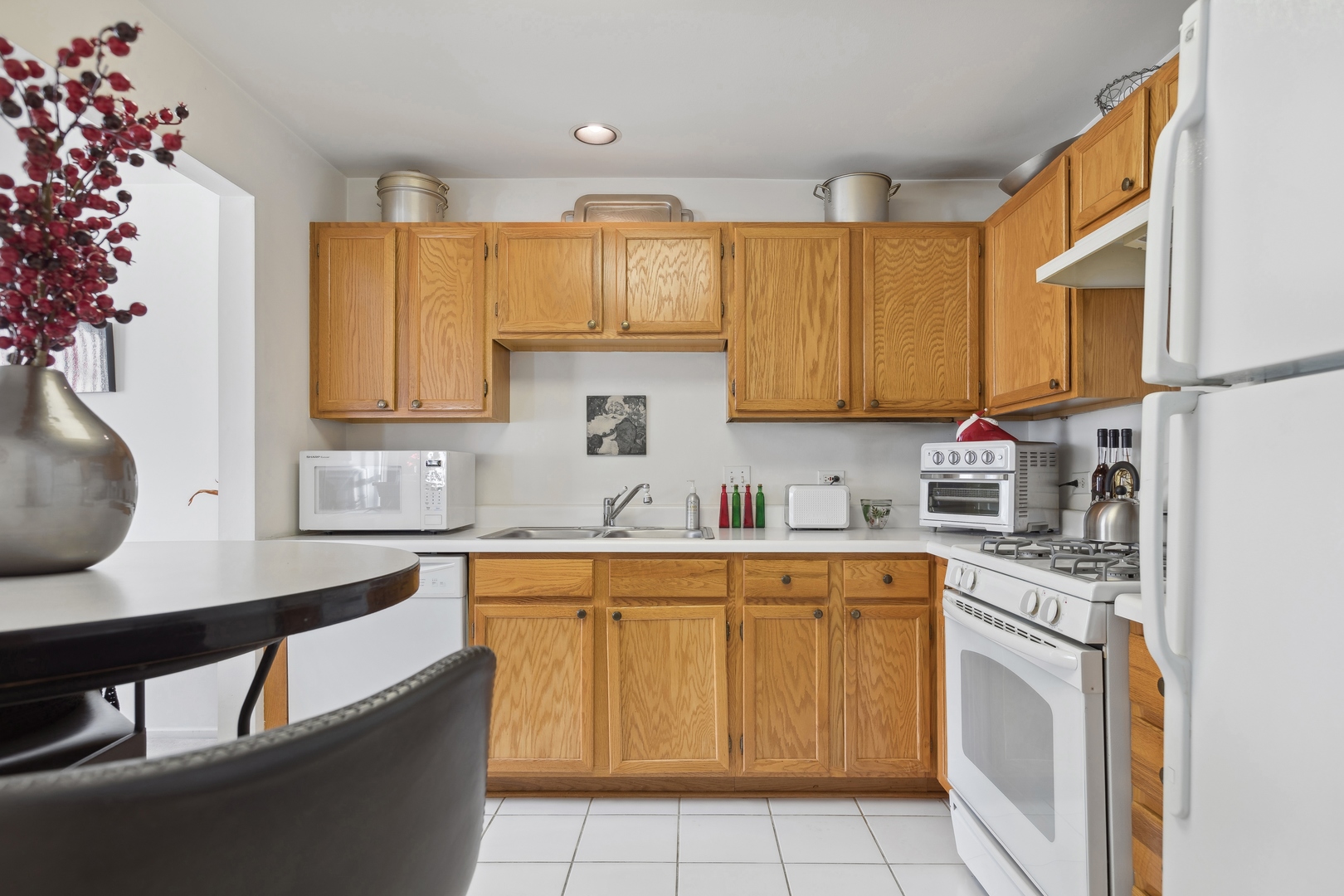 71 Larch Court, Unit B Schaumburg, IL 60193 - Photo 5 of 12 a kitchen with stainless steel appliances granite countertop a sink a stove and cabinets