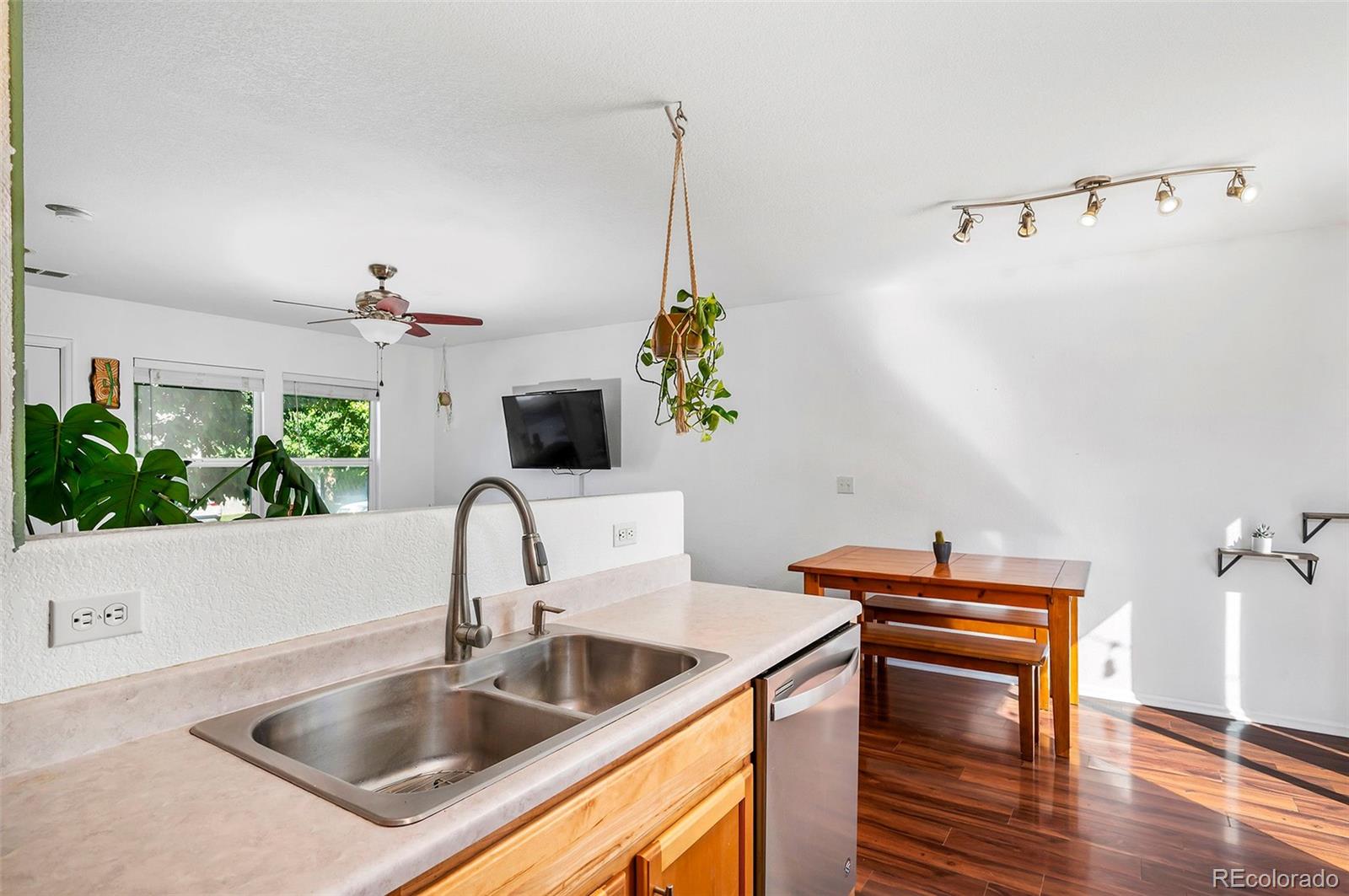 4570 South Swadley Court Morrison, CO 80465 - Photo 12 of 24 a kitchen with a sink cabinets and a wooden floor