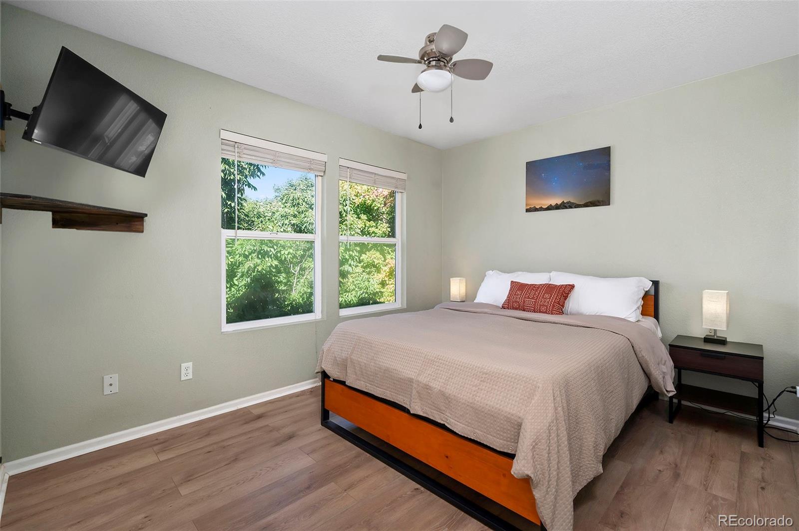 4570 South Swadley Court Morrison, CO 80465 - Photo 14 of 24 a large bed sitting in a bedroom next to a window