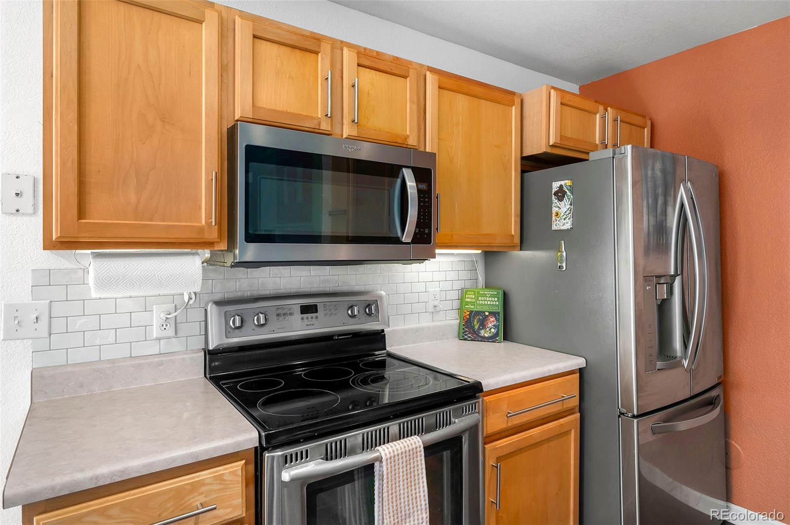 4570 South Swadley Court Morrison, CO 80465 - Photo 5 of 24 a kitchen with stainless steel appliances granite countertop a refrigerator stove and microwave