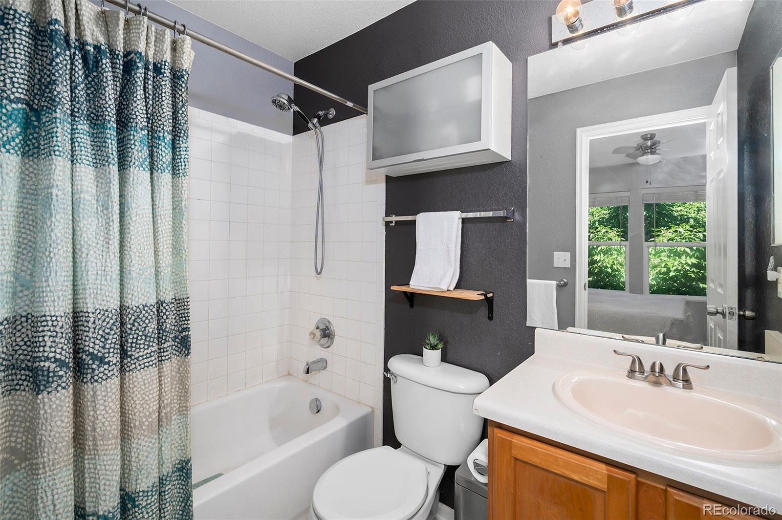 4570 South Swadley Court Morrison, CO 80465 - Photo 7 of 24 a bathroom with a sink toilet and shower