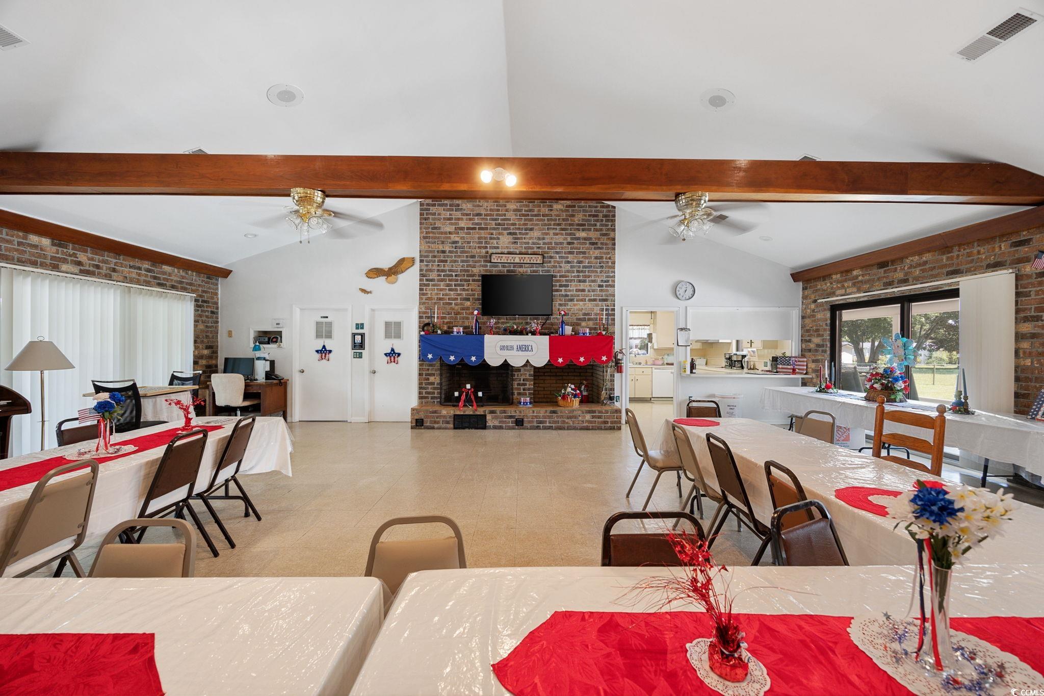983 South Marlin Circle Murrells Inlet, SC 29576 - Photo 36 of 40 Dining space with brick wall, beam ceiling, and high vaulted ceiling
