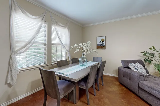 a dining room with furniture and window