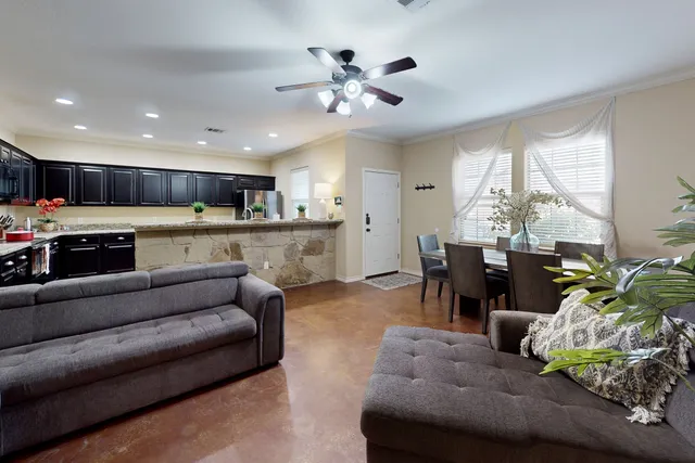 a living room with furniture and kitchen view