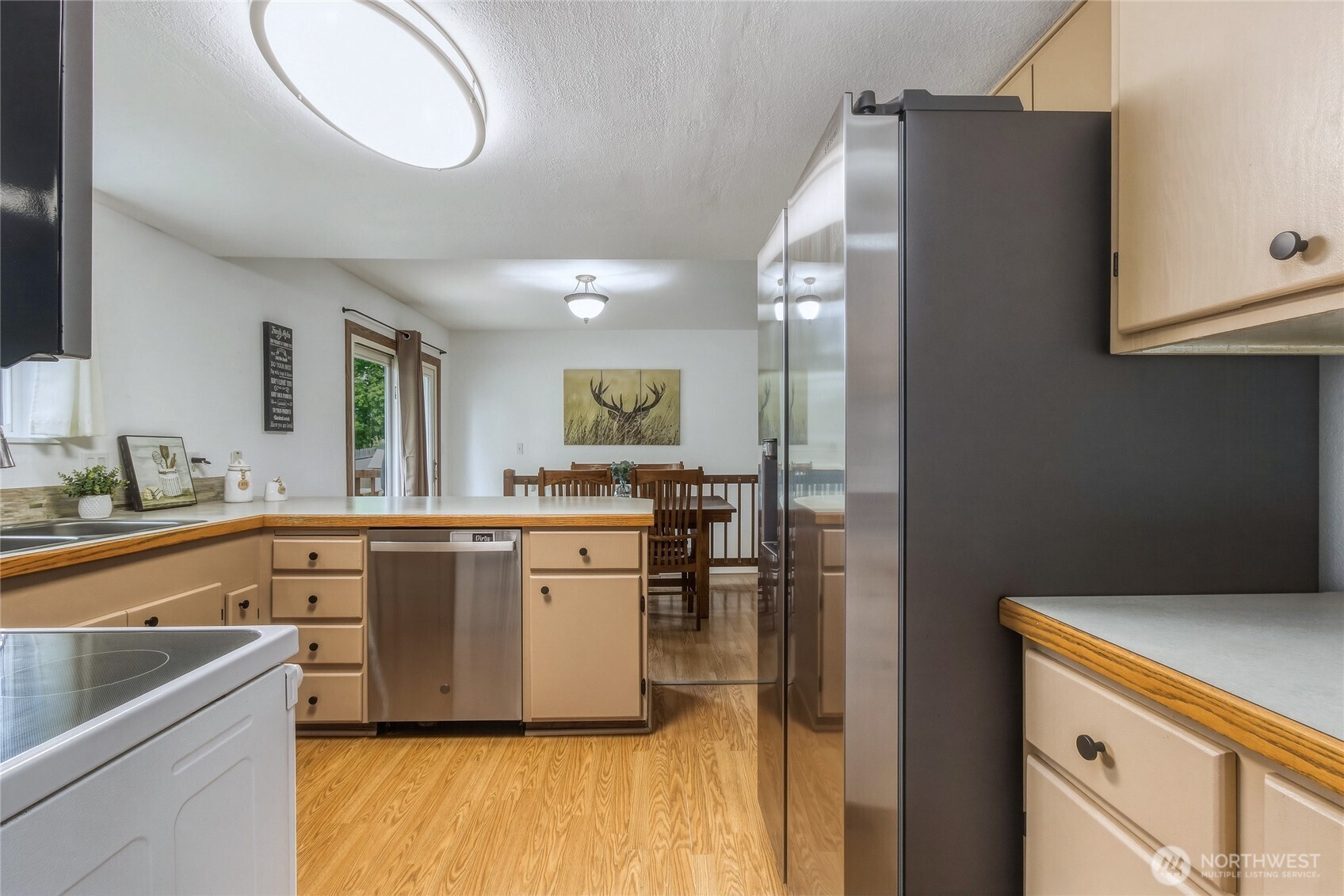 304 Southwest 11th Street College Place, WA 99324 - Photo 11 of 38 a kitchen with a refrigerator and a sink
