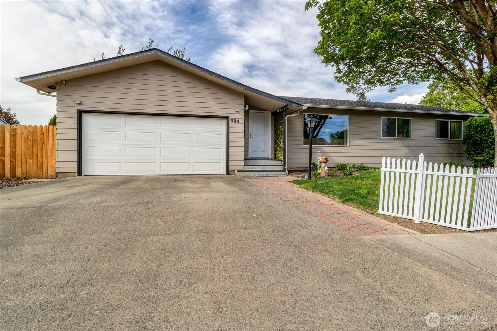 304 Southwest 11th Street College Place, WA 99324 - Photo 2 of 38 a front view of a house with a garage