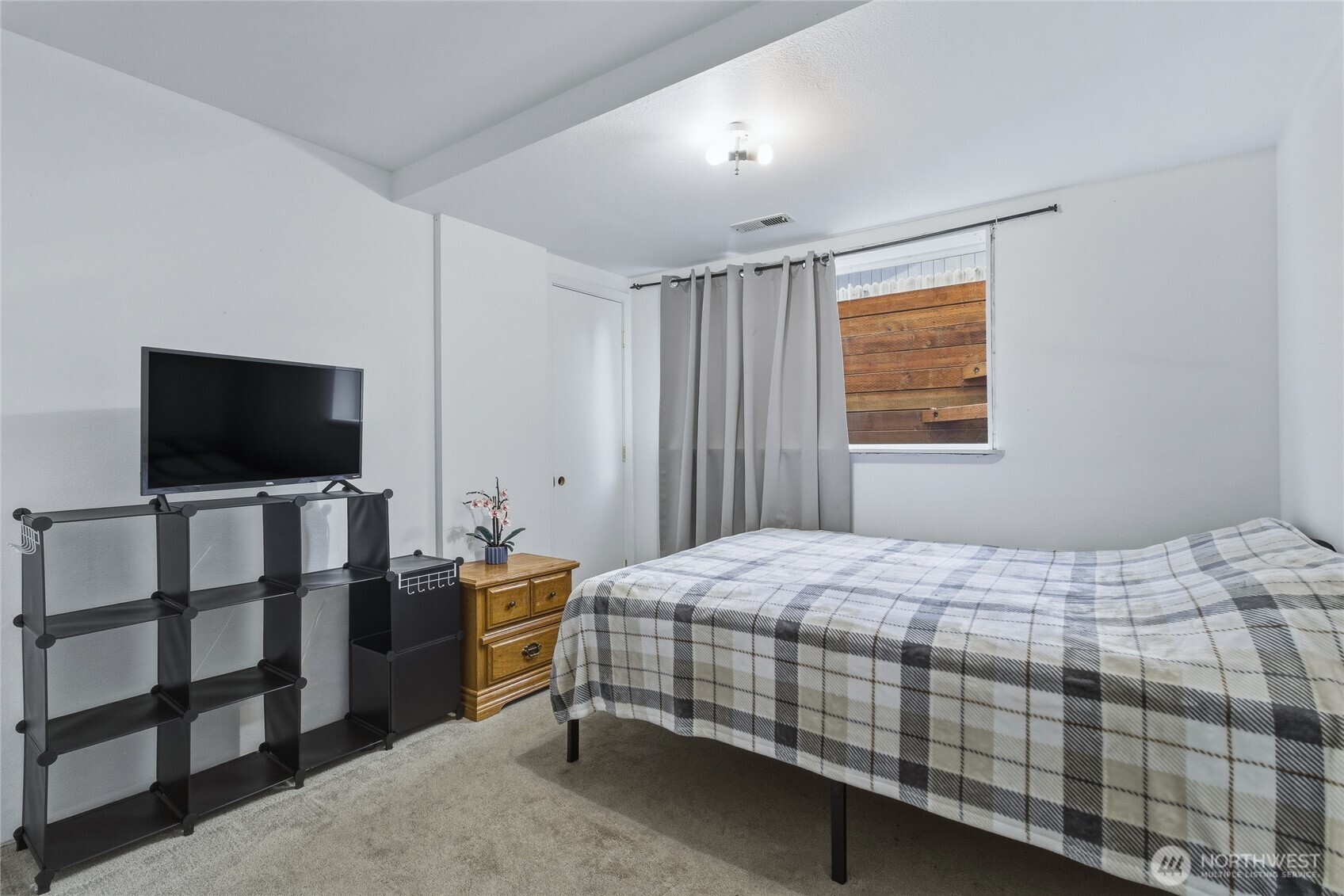 304 Southwest 11th Street College Place, WA 99324 - Photo 26 of 38 a bedroom with a bed and a flat screen tv