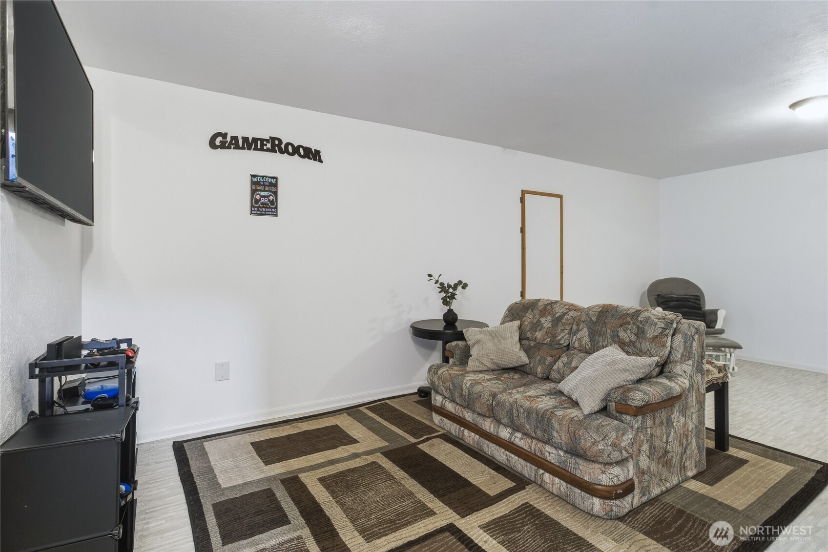 304 Southwest 11th Street College Place, WA 99324 - Photo 29 of 38 a living room with furniture and a flat screen tv