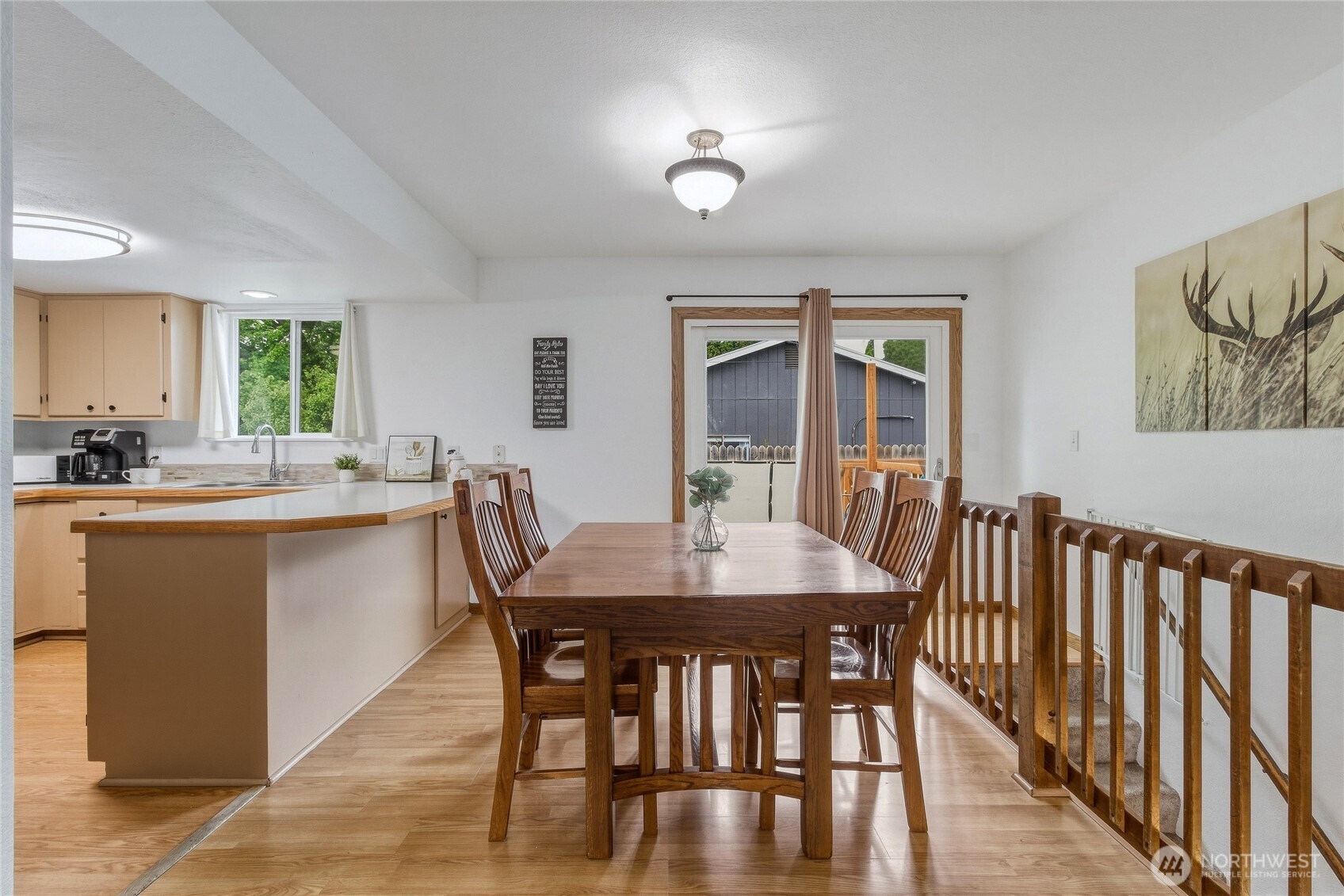 304 Southwest 11th Street College Place, WA 99324 - Photo 7 of 38 a kitchen with stainless steel appliances granite countertop a dining table chairs and a refrigerator