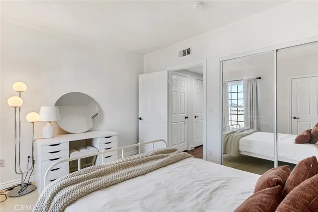 a bedroom with a bed and a mirror