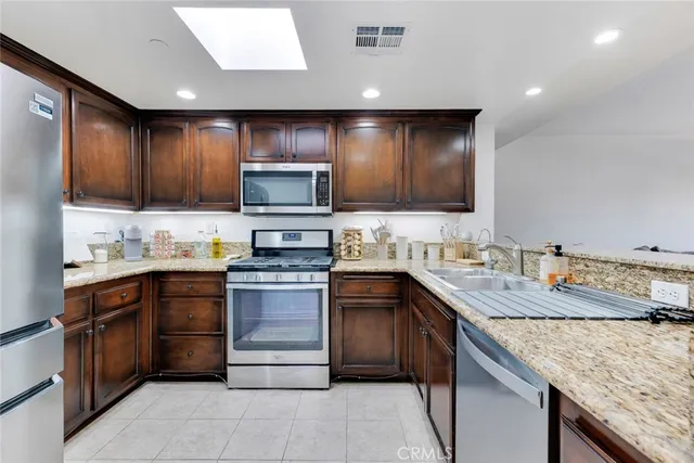 a kitchen with a sink stove top oven and cabinets