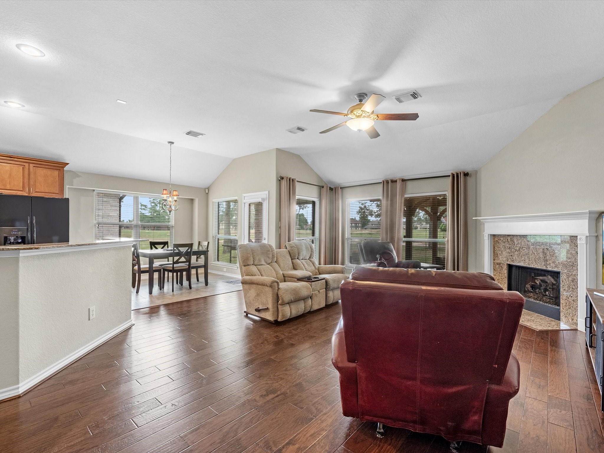 19019 Relay Road Humble, TX 77346 - Photo 9 of 31 a living room with furniture a fireplace and a dining table with wooden floor