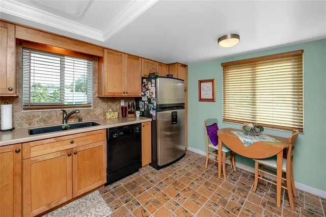 a kitchen with granite countertop a stove top oven microwave and cabinets