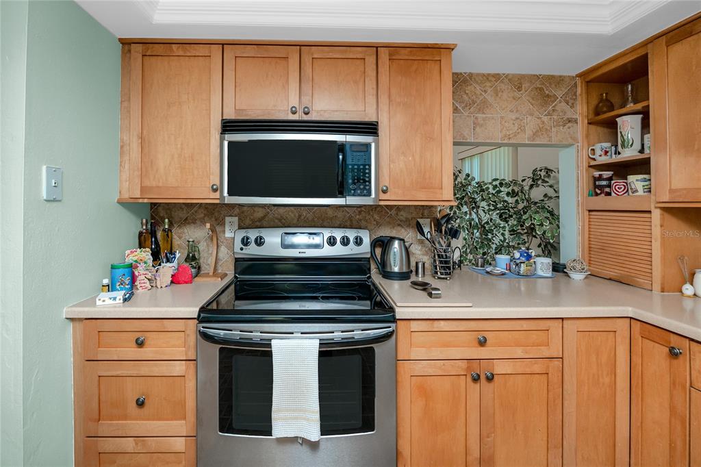 2737 Enterprise Road East, Unit 112 Clearwater, FL 33759 - Photo 15 of 43 a kitchen with stainless steel appliances a stove and a microwave