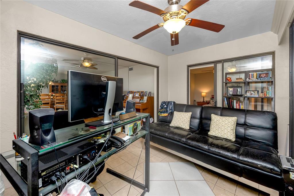 2737 Enterprise Road East, Unit 112 Clearwater, FL 33759 - Photo 20 of 43 a room with furniture and flat screen tv