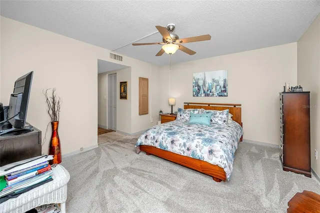 a bedroom with a bed and a tv