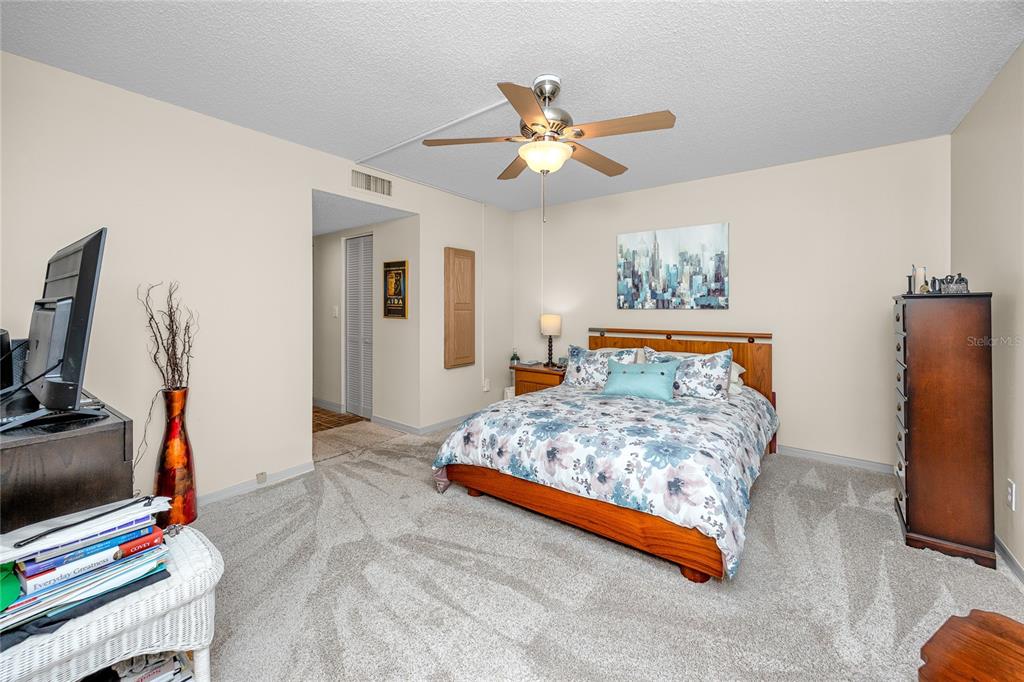 2737 Enterprise Road East, Unit 112 Clearwater, FL 33759 - Photo 21 of 43 a bedroom with a bed and a flat screen tv