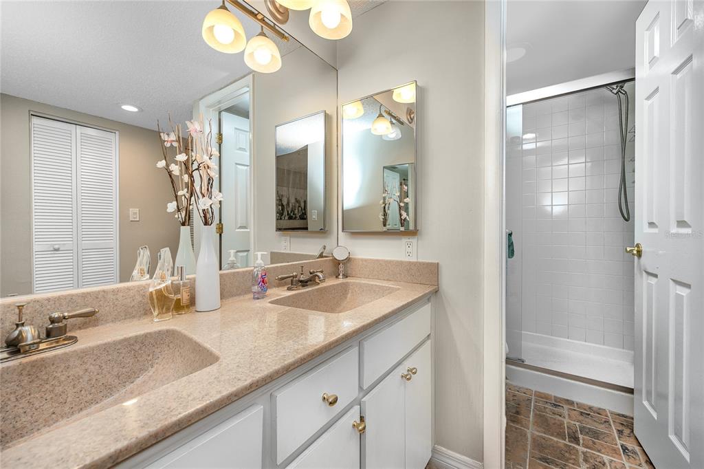 2737 Enterprise Road East, Unit 112 Clearwater, FL 33759 - Photo 25 of 43 a bathroom with a granite countertop sink and a mirror