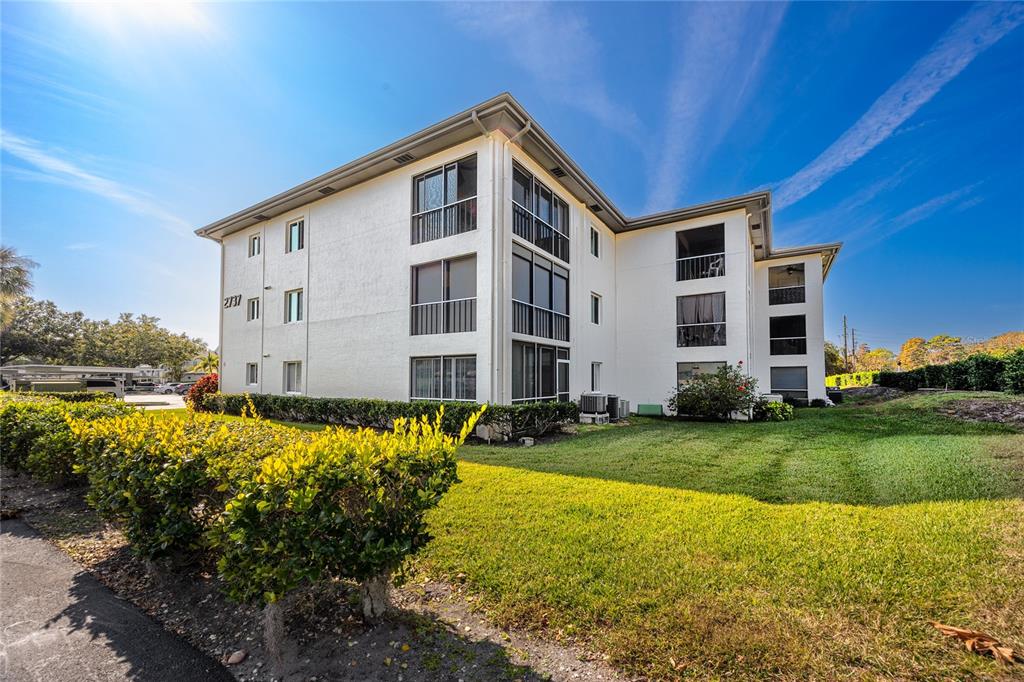 2737 Enterprise Road East, Unit 112 Clearwater, FL 33759 - Photo 3 of 43 a front view of a house with a yard