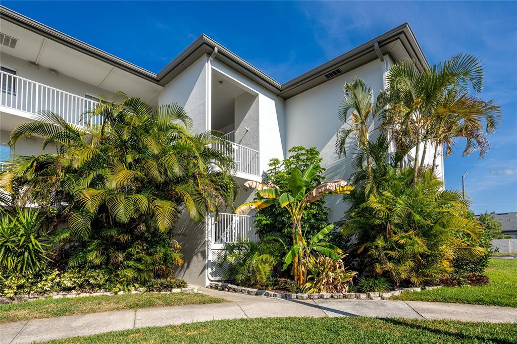 2737 Enterprise Road East, Unit 112 Clearwater, FL 33759 - Photo 4 of 43 a front view of a house with garden