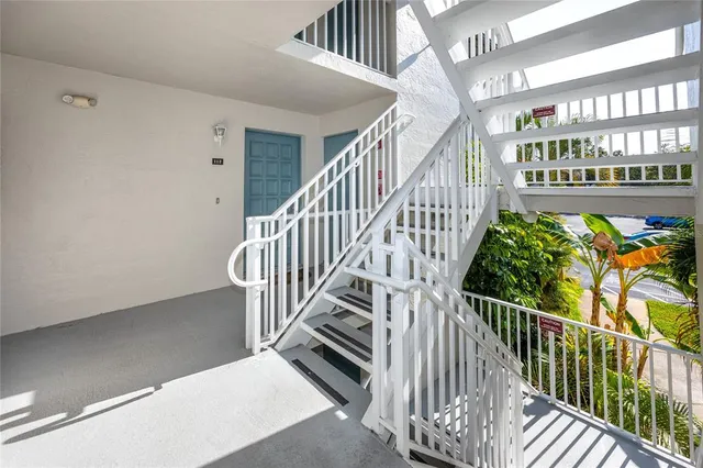 a view of staircase with lots of frames on wall