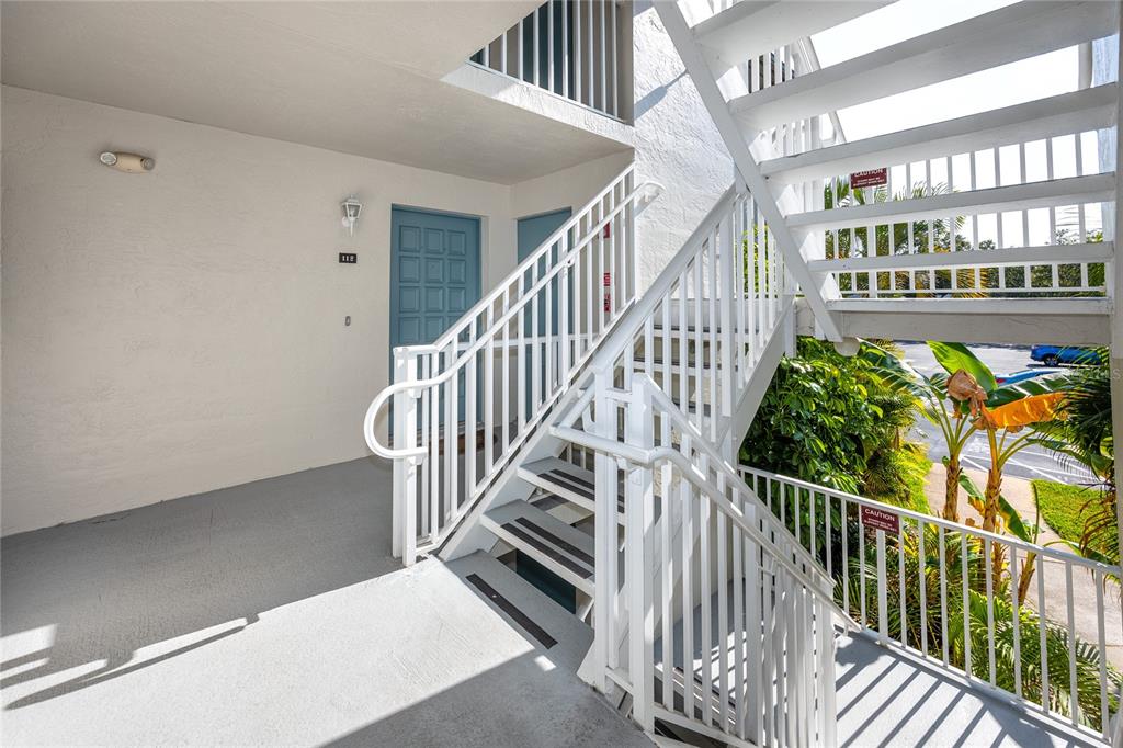 2737 Enterprise Road East, Unit 112 Clearwater, FL 33759 - Photo 5 of 43 a view of staircase with lots of frames on wall