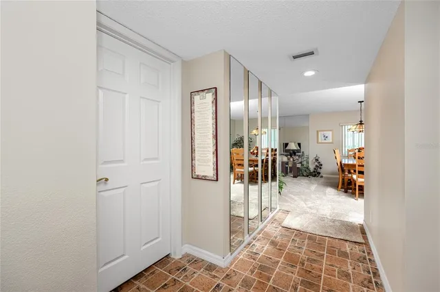 a view of a hallway with a livingroom and a livingroom