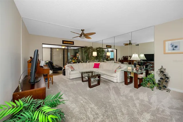 a living room with lots of furniture and clutter