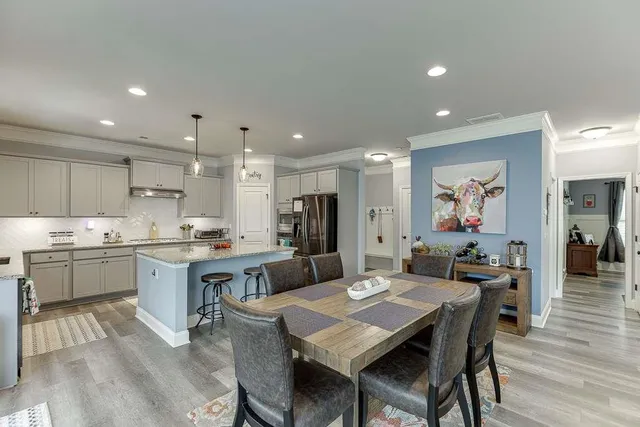 a large kitchen with a table and chairs in it