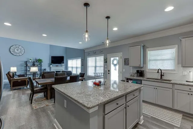 a kitchen with sink stove and cabinets