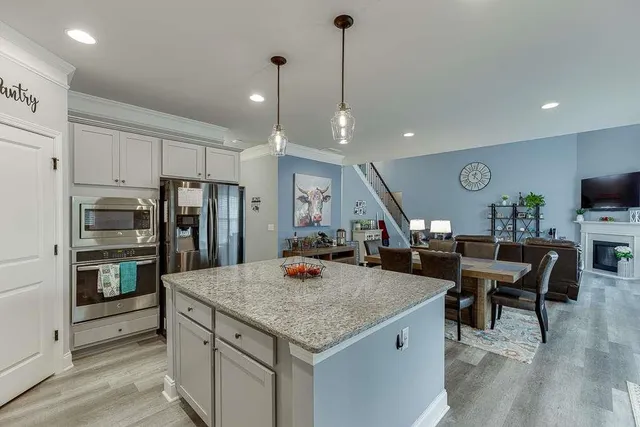 a view of a kitchen with a table and chairs