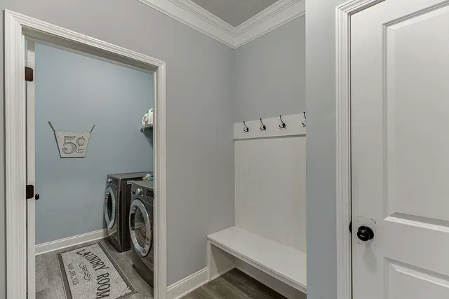 a view of a storage and utility room with washer and dryer