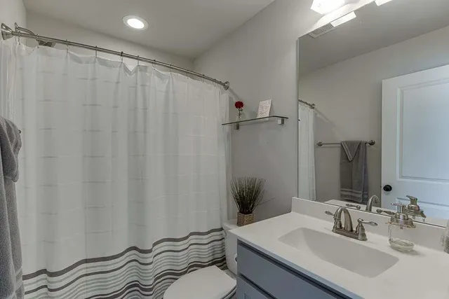 a bedroom with a bed couch and window