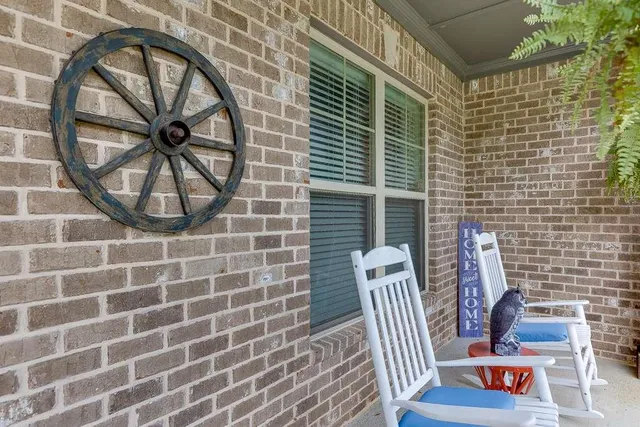 a view of a brick wall with two windows
