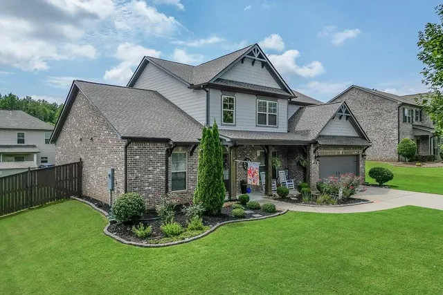 a aerial view of a house with table and chairs under an umbrella
