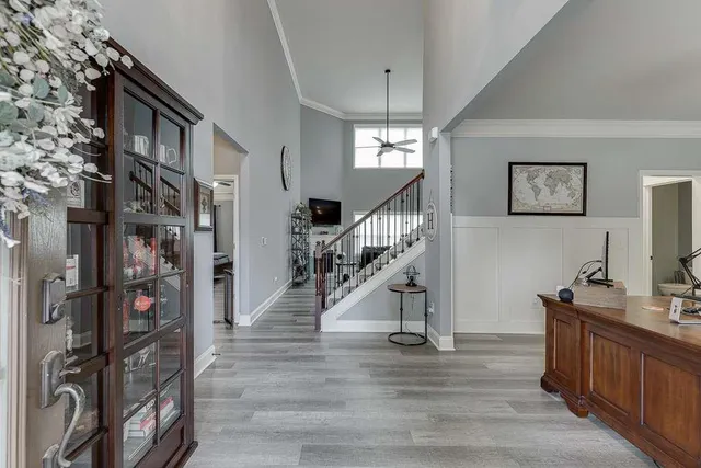 a view of entryway and hall with wooden floor