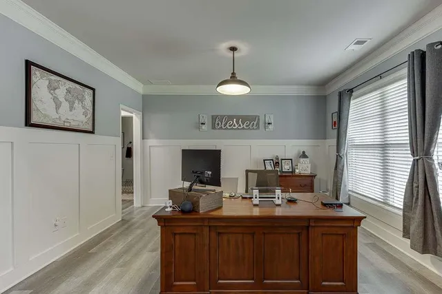 a view of a workspace with furniture and a window