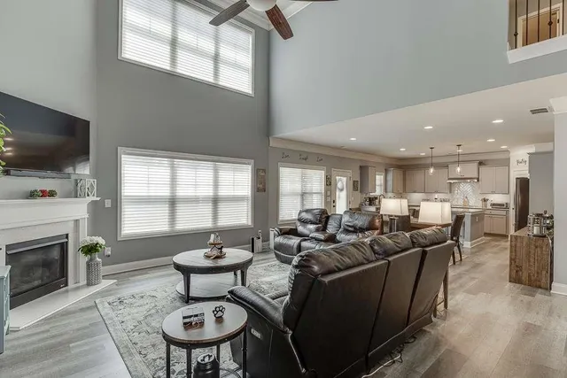a living room with fireplace furniture and a flat screen tv