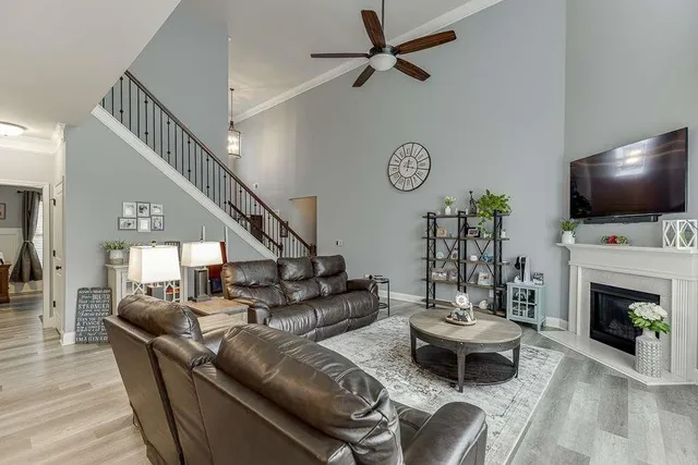 a living room with furniture a fireplace and a flat screen tv
