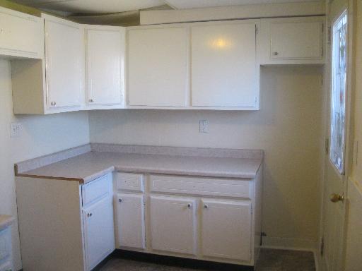 519 West State Street Sycamore, IL 60178 - Photo 8 of 16 a kitchen with white cabinets and a white stove